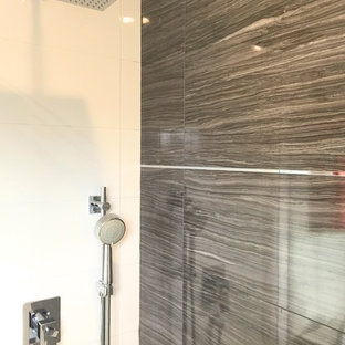 Inspiration for a medium sized classic shower room bathroom in Toronto with flat-panel cabinets, white cabinets, an alcove shower, grey tiles, porcelain tiles, white walls, porcelain flooring, an integrated sink, solid surface worktops, grey floors and a sliding door.