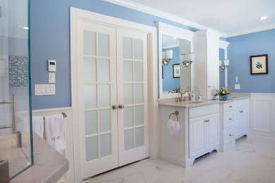Large elegant master blue tile porcelain tile and white floor bathroom photo in Boston with raised-panel cabinets, white cabinets, a one-piece toilet, blue walls, an undermount sink, quartz countertops and a hinged shower door