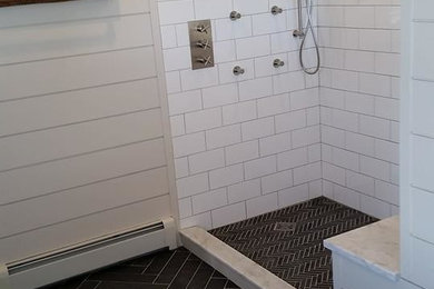 Inspiration for a medium sized country ensuite bathroom in Burlington with freestanding cabinets, medium wood cabinets, a freestanding bath, a two-piece toilet, black and white tiles, stone tiles, beige walls, slate flooring, an integrated sink and marble worktops.