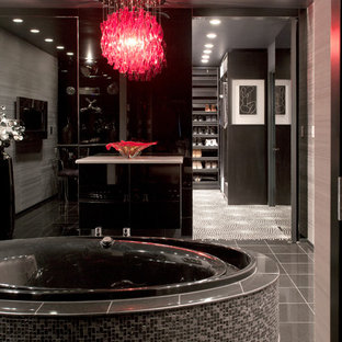 Trendy ceramic tile and blue floor bathroom photo in Seattle with a wall-mount toilet and black walls