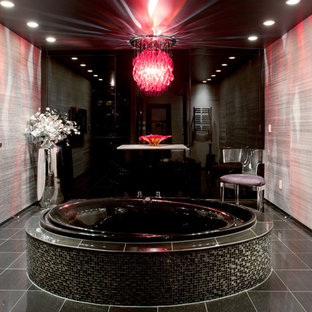 Example of a trendy ceramic tile and blue floor bathroom design in Seattle with a wall-mount toilet and black walls