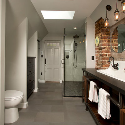 Inspiration for a large industrial master gray tile and porcelain tile porcelain tile corner shower remodel in DC Metro with a trough sink, open cabinets, dark wood cabinets, quartz countertops and gray walls