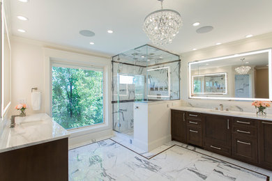 Large classic ensuite bathroom in Denver with recessed-panel cabinets, dark wood cabinets, an alcove shower, a wall mounted toilet, white tiles, marble tiles, white walls, marble flooring, a submerged sink, marble worktops, white floors, a hinged door and white worktops.