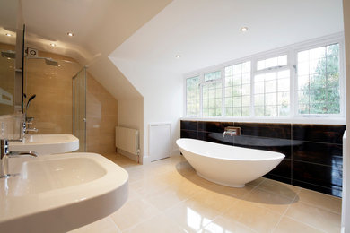 Design ideas for a large modern family bathroom in West Midlands with a freestanding bath, a walk-in shower, a one-piece toilet, brown walls, terracotta flooring and a wall-mounted sink.