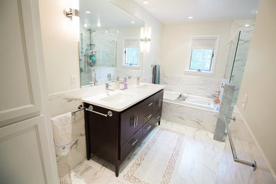 Bathroom - mid-sized contemporary master marble floor bathroom idea in Boston with flat-panel cabinets, dark wood cabinets, a two-piece toilet, white walls, an undermount sink and solid surface countertops