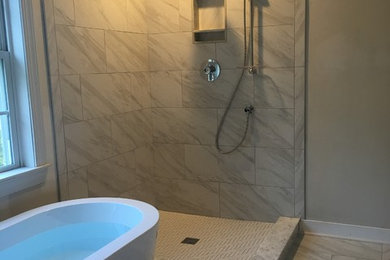 Design ideas for a medium sized modern ensuite bathroom in Richmond with freestanding cabinets, white cabinets, a freestanding bath, a corner shower, a two-piece toilet, white tiles, porcelain tiles, green walls, porcelain flooring, a submerged sink, marble worktops, white floors, a hinged door and grey worktops.