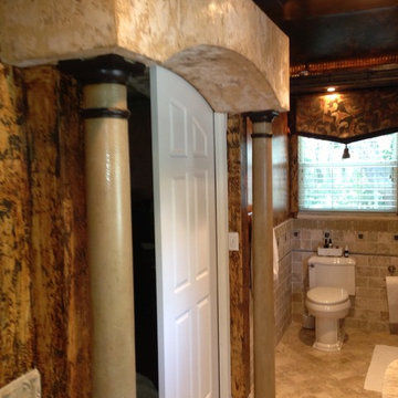 Masterbath with arched pocket doors and two hall bathroom with wainscot.