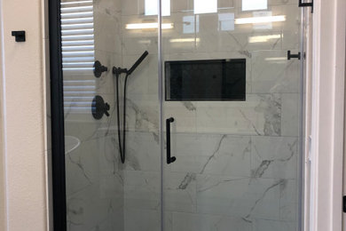 Inspiration for a mid-sized transitional master porcelain tile porcelain tile and black floor bathroom remodel in Sacramento with shaker cabinets, white cabinets, an undermount sink, quartz countertops and a hinged shower door