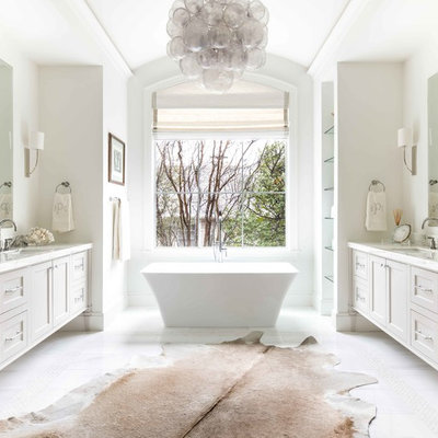 Inspiration for a coastal master white floor freestanding bathtub remodel in Dallas with furniture-like cabinets, gray cabinets, white walls, an undermount sink and white countertops