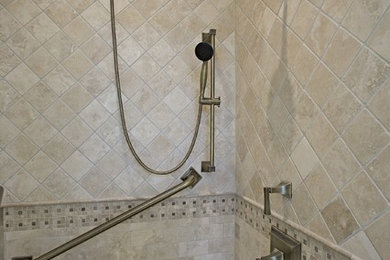 На фото: ванная комната с бежевой плиткой, душем в нише и душем с распашными дверями с