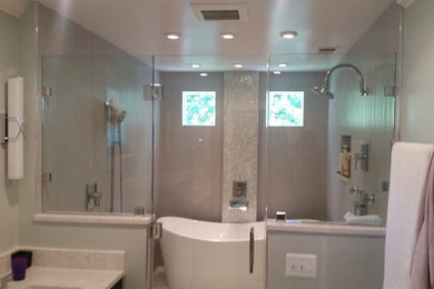 Photo of a medium sized traditional ensuite bathroom in DC Metro with a freestanding bath, a shower/bath combination, beige tiles, porcelain tiles, green walls, porcelain flooring, a submerged sink, engineered stone worktops, beige floors, a hinged door, shaker cabinets and dark wood cabinets.