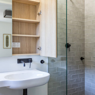 Photo of a small traditional shower room bathroom in Sydney with glass-front cabinets, light wood cabinets, an alcove shower, a one-piece toilet, grey tiles, ceramic tiles, white walls, slate flooring, a wall-mounted sink, black floors and an open shower.