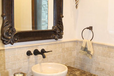 Photo of a small mediterranean shower room bathroom in San Luis Obispo with a vessel sink, freestanding cabinets, dark wood cabinets, marble worktops, beige tiles, stone tiles and beige walls.