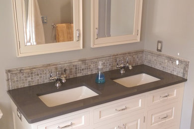 Example of a mid-sized classic kids' multicolored tile and stone tile travertine floor bathroom design in Philadelphia with an undermount sink, raised-panel cabinets, beige cabinets, quartz countertops, a two-piece toilet and gray walls