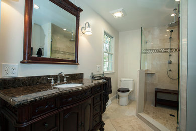 Alcove shower - mid-sized traditional master beige tile and ceramic tile ceramic tile alcove shower idea in Philadelphia with an undermount sink, furniture-like cabinets, dark wood cabinets, granite countertops, a one-piece toilet and white walls