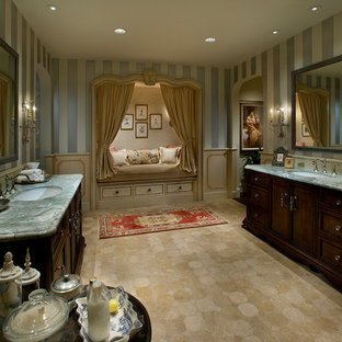 Bathroom - large mediterranean master beige tile and stone tile limestone floor bathroom idea in Phoenix with an undermount sink, furniture-like cabinets, dark wood cabinets, marble countertops and multicolored walls