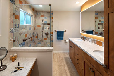 Eclectic master multicolored tile and ceramic tile vinyl floor and beige floor bathroom photo in San Francisco with shaker cabinets, medium tone wood cabinets, an undermount sink, quartz countertops, a hinged shower door and beige countertops