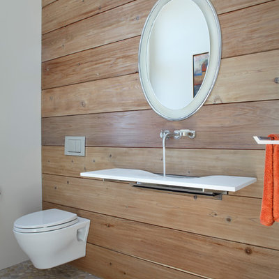 Inspiration for a contemporary pebble tile floor bathroom remodel in Santa Barbara with a wall-mount toilet and a wall-mount sink