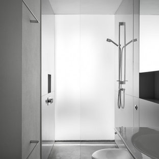 Photo of a medium sized modern shower room bathroom in London with a walk-in shower, a wall mounted toilet, grey walls, concrete flooring, a wall-mounted sink and grey floors.