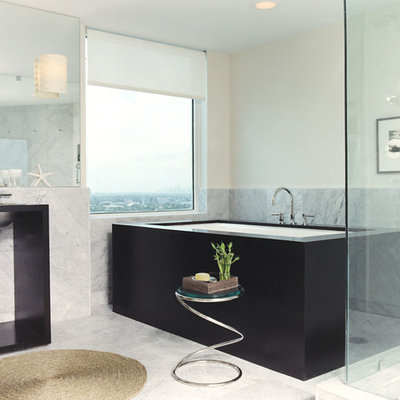 Example of a trendy freestanding bathtub design in New York with a wall-mount sink