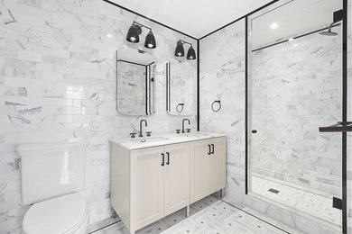 Example of a mid-sized trendy 3/4 gray tile and marble tile marble floor and gray floor alcove shower design in Chicago with recessed-panel cabinets, beige cabinets, a two-piece toilet, gray walls, an undermount sink, marble countertops, a hinged shower door and gray countertops