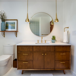Inspiration for a mid-sized 1960s white tile and ceramic tile white floor and porcelain tile bathroom remodel in Los Angeles with medium tone wood cabinets, white walls, quartz countertops, furniture-like cabinets, a two-piece toilet, an undermount sink and a hinged shower door