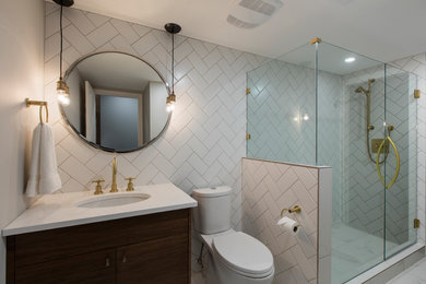 Inspiration for a 1950s gray tile black floor alcove shower remodel in Vancouver with flat-panel cabinets, white cabinets, gray walls, an undermount sink, marble countertops and a hinged shower door