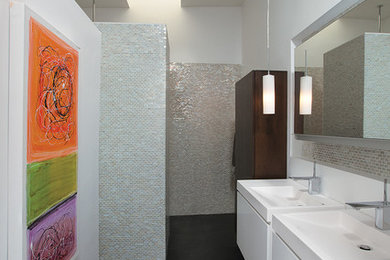 Photo of a midcentury bathroom in Atlanta with mosaic tiles.