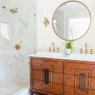 Example of a mid-century modern 3/4 white tile mosaic tile floor and white floor corner shower design in Other with furniture-like cabinets, medium tone wood cabinets, white walls, a drop-in sink, a hinged shower door and white countertops