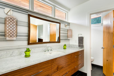 Mid-sized 1960s black and white tile and ceramic tile ceramic tile bathroom photo in Denver with flat-panel cabinets, medium tone wood cabinets, an undermount sink and marble countertops