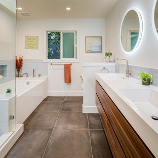 Photo of a large midcentury bathroom in San Francisco with an open shower, an undermount tub, a two-piece toilet, blue tile, ceramic tile, white walls, ceramic floors, yellow benchtops, flat-panel cabinets, medium wood cabinets, a niche, a double vanity and a floating vanity.