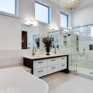 Example of a huge trendy master white tile and porcelain tile ceramic tile, white floor and double-sink bathroom design in Portland with flat-panel cabinets, white cabinets, white walls, quartz countertops, white countertops and an undermount sink