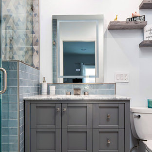 Example of a small 1950s kids' blue tile and ceramic tile marble floor, white floor and single-sink alcove shower design in Los Angeles with shaker cabinets, gray cabinets, a two-piece toilet, white walls, an undermount sink, marble countertops, a hinged shower door, white countertops, a niche and a freestanding vanity