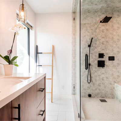 Example of a mid-sized transitional master gray tile and ceramic tile ceramic tile, white floor and single-sink bathroom design in Los Angeles with flat-panel cabinets, medium tone wood cabinets, an undermount sink, marble countertops, a hinged shower door, white countertops and a built-in vanity