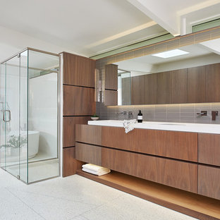 Bathroom - huge 1950s master gray tile and subway tile concrete floor and white floor bathroom idea in Grand Rapids with flat-panel cabinets, white walls, a trough sink, a hinged shower door, dark wood cabinets and wood countertops