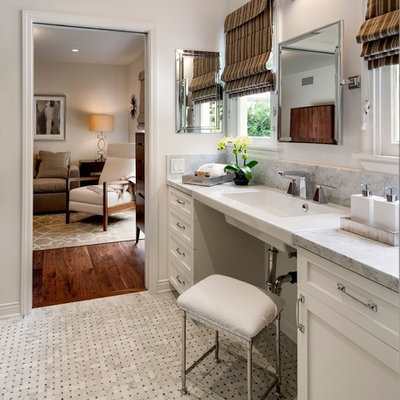 Mid-sized transitional gray tile and stone tile mosaic tile floor bathroom photo in Los Angeles with shaker cabinets, white cabinets, gray walls, a wall-mount sink, a one-piece toilet, marble countertops and gray countertops