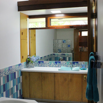 Midcentury modern bathroom vanity with solid surface countertop and Turquoise si