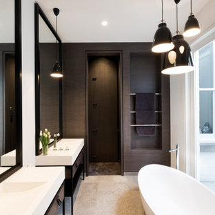 Inspiration for a mid-sized contemporary master bathroom in Melbourne with a freestanding tub, white tile, porcelain tile, porcelain floors, soapstone benchtops, white benchtops, a double vanity, a freestanding vanity, flat-panel cabinets, a console sink and grey floor.