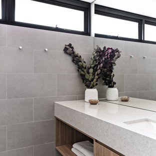 Inspiration for a small contemporary master wet room bathroom in Sydney with brown cabinets, a one-piece toilet, gray tile, porcelain tile, grey walls, porcelain floors, an undermount sink, engineered quartz benchtops, grey floor, an open shower, grey benchtops, a single vanity and a floating vanity.