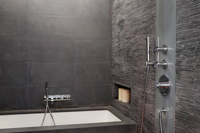 Example of a huge trendy master gray tile and matchstick tile medium tone wood floor bathroom design in New York with gray walls