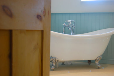 This is an example of a medium sized traditional family bathroom in Surrey with shaker cabinets, beige cabinets, a freestanding bath, a corner shower, a two-piece toilet, beige tiles, limestone tiles, white walls, limestone flooring, a console sink, wooden worktops, an open shower, beige worktops, a single sink, a freestanding vanity unit and tongue and groove walls.