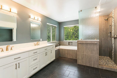Mid-sized trendy master multicolored tile and stone tile ceramic tile and brown floor bathroom photo in Seattle with beaded inset cabinets, white cabinets, a one-piece toilet, gray walls, an integrated sink and granite countertops