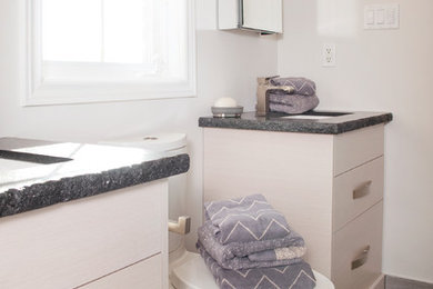 Bathroom - small modern kids' gray tile and porcelain tile porcelain tile bathroom idea in Toronto with an undermount sink, furniture-like cabinets, light wood cabinets, granite countertops, a two-piece toilet and white walls