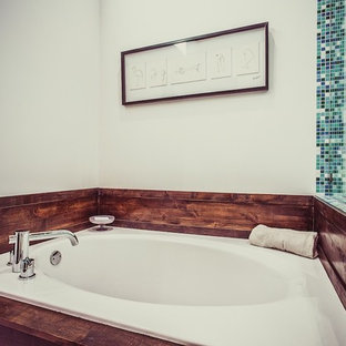 Photo of a midcentury master bathroom in Salt Lake City with flat-panel cabinets, dark wood cabinets, an open shower, blue tile, mosaic tile, a hinged shower door, a shower seat, a double vanity, a floating vanity and wood.
