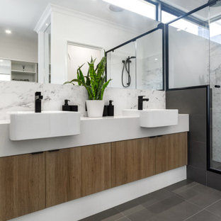 Photo of a large contemporary master bathroom in Perth with flat-panel cabinets, beige cabinets, an alcove shower, gray tile, porcelain tile, porcelain floors, a vessel sink, grey floor, a hinged shower door, white benchtops, a double vanity and a built-in vanity.