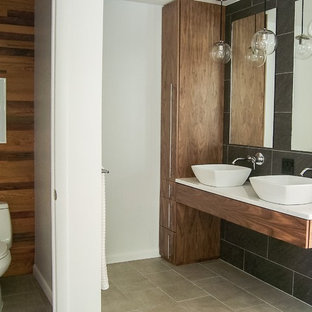 Mid-sized minimalist master gray tile and ceramic tile ceramic tile freestanding bathtub photo in Grand Rapids with quartzite countertops, flat-panel cabinets, medium tone wood cabinets, a one-piece toilet, a vessel sink and multicolored walls