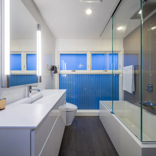 Bathroom - modern gray tile bathroom idea in Minneapolis with an integrated sink, flat-panel cabinets, white cabinets and white countertops