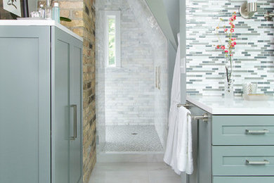 Inspiration for a large transitional master blue tile and glass tile marble floor alcove shower remodel in Minneapolis with flat-panel cabinets, gray cabinets, an undermount tub, a one-piece toilet, blue walls, an undermount sink and quartzite countertops