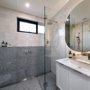 Photo of a mid-sized contemporary 3/4 bathroom in Sydney with shaker cabinets, white cabinets, a double shower, a wall-mount toilet, multi-coloured tile, porcelain tile, marble floors, an undermount sink, marble benchtops, a hinged shower door, white benchtops, a single vanity and a floating vanity.