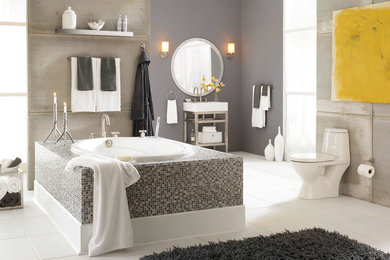 Drop-in bathtub - mid-sized transitional master gray tile and cement tile ceramic tile and white floor drop-in bathtub idea in Other with a one-piece toilet, open cabinets, gray walls, a console sink and solid surface countertops